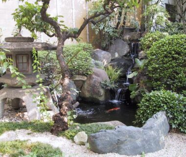Koi pond with stone lantern and greenery at Ryokan Matsushima Kanagawa