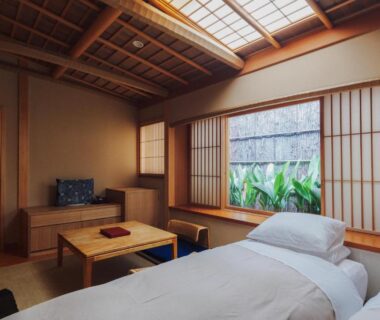 Tatami room with futon bedding, shoji screens and low table at Ryokan Motonago in Kyoto, Kansai, Japan
