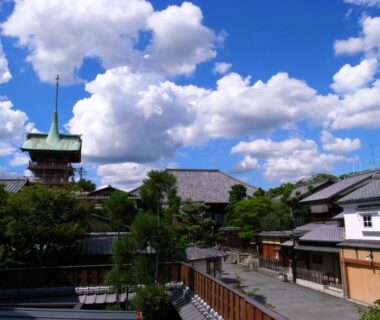 Blue sky over traditional wooden buildings and tiled roofs near Ryokan Motonago in Kyoto, Kansai