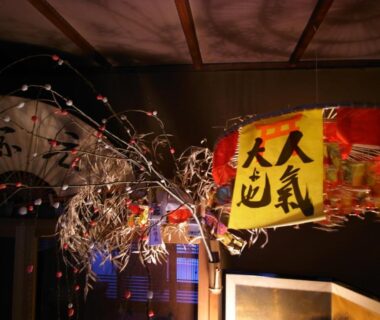 Hanging paper lantern and decorative branches with Japanese calligraphy banner inside Ryokan Motonago Kyoto