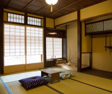 Tatami room with low table, zabuton cushions and shoji screens at Ryokan Mugen Kyoto