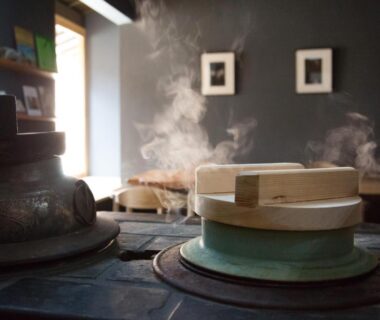 Steaming pots with wooden lids on traditional stove inside Ryokan Mugen, Kyoto, Kansai