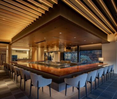 U-shaped teppanyaki counter with wooden slatted ceiling and stools at Ryokan Onomichi Nishiyama in Hiroshima
