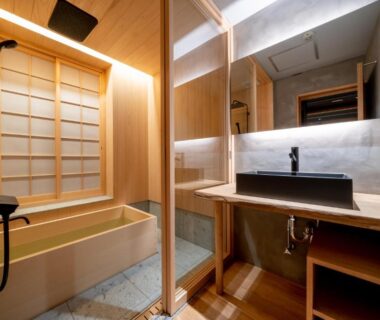 Bathroom with wooden bathtub, shower, shoji screen, and sink at Ryokan Ryokufuso Kyoto