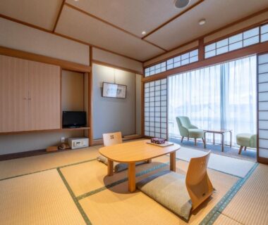 Tatami room with low table, floor chairs and shoji screens at Ryokan Ryokufuso in Kyoto, Kansai