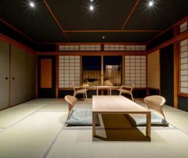 Traditional tatami room with low wooden table, zaisu chairs and shoji screens at Ryokan Ryokufuso, Kyoto