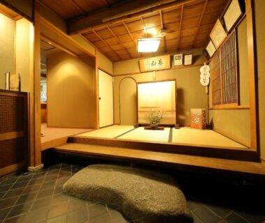 Elevated tatami room with shoji screens, tokonoma alcove and stone entrance step