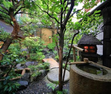 Stone water basin and lantern in courtyard garden at Ryokan Sanga Kyoto, Kansai, Japan