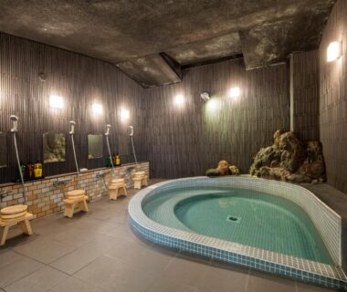 Indoor tiled onsen with wash stations at Ryokan Sanoya in Kyoto, Kansai