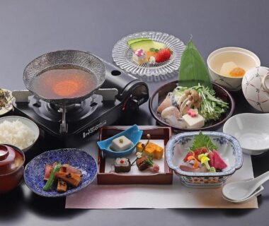 Assorted Japanese small dishes and tabletop hot pot on lacquer tray at Ryokan Sanoya, Kyoto