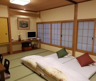Tatami room with futon bedding and shoji screens at Ryokan Sawaya Honten, Kyoto