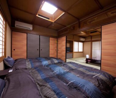 Tatami room with futon bedding, shoji screens and skylight at Ryokan Sennari, Ōita, Kyūshū, Japan