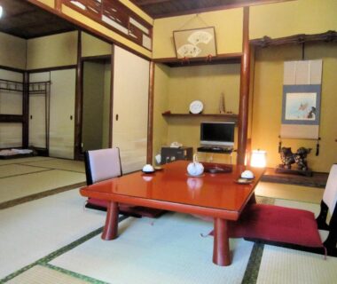 Traditional tatami room with low lacquered table, zaisu chairs, tokonoma alcove and shoji screens at Ryokan Taishoro in Nara