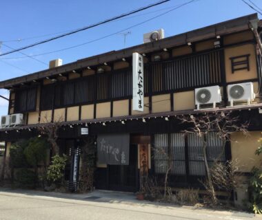 Two-story wooden ryokan facade with noren entrance, Ryokan Takayama in Chūbu, Gifu, Japan