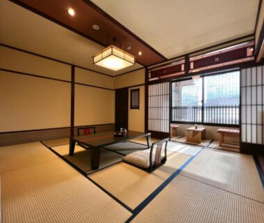 Traditional tatami room with low table, shoji screens and seating at Ryokan Tanabe in Gifu, Chūbu