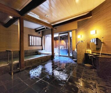 Spacious indoor onsen with wooden walls and tiled floor at Ryokan Tanabe, Gifu, Chūbu, Japan