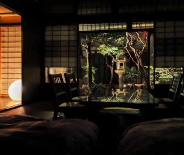 Traditional tatami room with shoji screens and courtyard garden at Ryokan Tanoya in Kyoto Kansai
