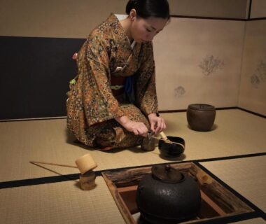 Woman performing tea ceremony in tatami room at Ryokan Tori in Kyoto
