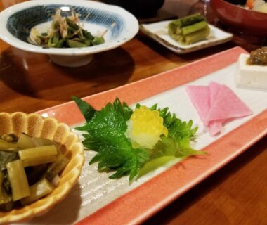 Assorted side dishes with shiso leaf on rectangular ceramic plate at Ryokan Yamakanoyu, Nagano