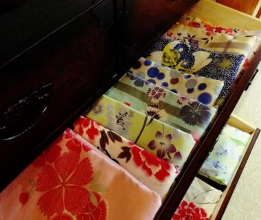 Drawer of folded colorful patterned robes in Ryokan Yamakanoyu guest room, Nagano, Chūbu, Japan
