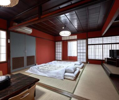 Tatami room with futons, shoji screens and low table at Ryokan Yamamuro in Ishikawa, Chūbu