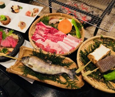 Grilled fish, sliced meat and vegetables on platters with tabletop grill at Ryokan Yamanoyu Kumamoto