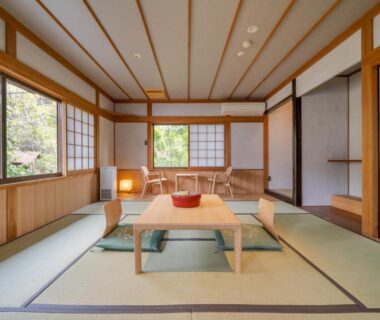 Traditional tatami room with low table and floor cushions at Ryokan Yamazaki in Kyoto
