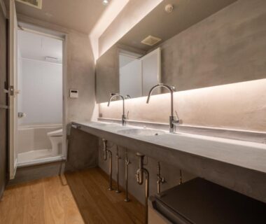 Double sink wash area with mirrors, wooden floor and shower cubicle at Ryokan Yamazaki, Kyoto