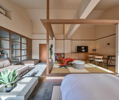 Light-filled interior with tatami, western bed, sofa and shoji screens at Ryokan Yoshidaya Saga
