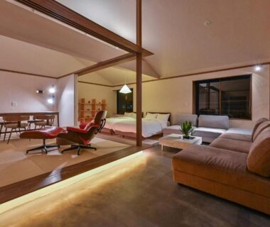 Spacious room with tatami sleeping area, low beds, sofa seating, shoji screens and dining table