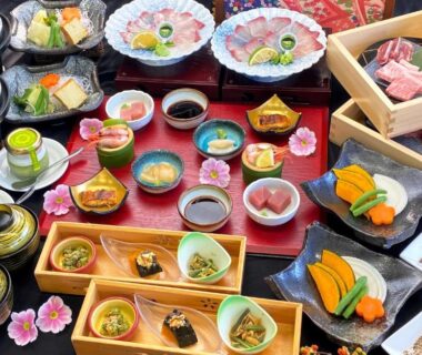Lacquer trays with assorted small Japanese dishes and sashimi at Ryokan Yufusan in Ōita, Kyūshū