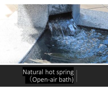 Water flowing into a stone hot spring basin at Ryokan Miyajima-an, Hiroshima