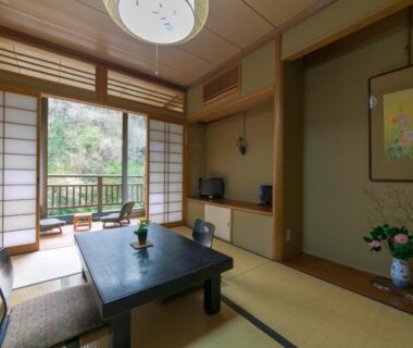 Tatami room with low table, shoji screens, tokonoma and balcony garden view at Ryori Ryokan Shikanoyu, Gifu, Chūbu