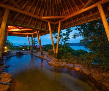 Covered wooden-roof onsen bath overlooking water at Ryoso Uminocho in Mie, Kansai