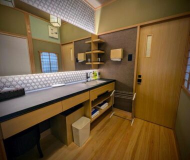 Japanese-style washstand with wooden flooring, counter, mirror and shoji windows in Ryoso Yufuin Yamadaya, Ōita
