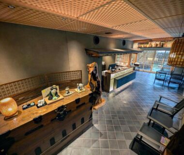 Reception desk and seating area with tiled floor at Ryoso Yufuin Yamadaya in Ōita, Kyūshū