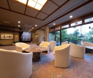Curved lounge chairs and low tables at Ryotei Jyusouya overlooking a Japanese garden in Nara