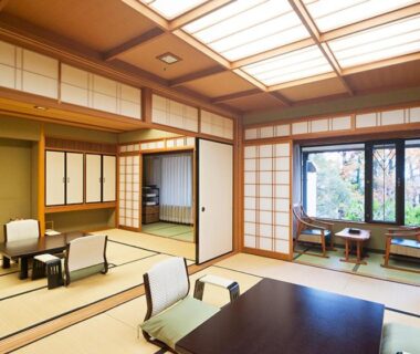 Traditional tatami room with low table, zaisu chairs, shoji screens and garden view at Ryotei Manyou in Ishikawa