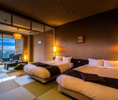 Tatami room with twin beds, balcony and sea view at Ryotei Matsubaya in Oita, Kyushu