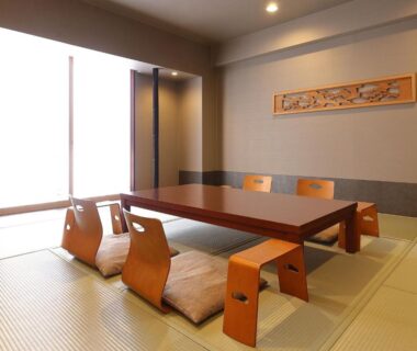 Tatami room with low wooden table and zaisu chairs at Ryotei Matsuya Honkan Suizenji, Kumamoto Kyushu