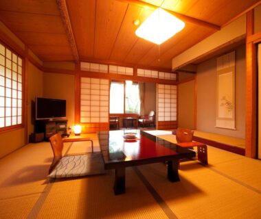 Tatami room with low table, shoji screens and tokonoma at Ryotei Tanokura in Ōita, Kyūshū
