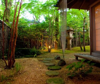 Stepping stone path, shoji-screened porch and stone lantern in Ryotei Tanokura garden, Oita