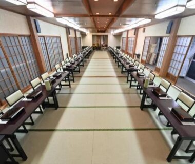Long tatami dining room with low tables, chairs and shoji screens at Ryoufuso in Mie, Kansai