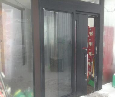 Fogged glass sliding entrance with decorative fabric panel beside doorway at Ryounkaku in Hokkaido