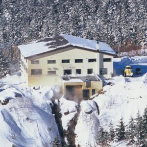 Snow-covered building perched on mountainside at Ryounkaku in Hokkaidō
