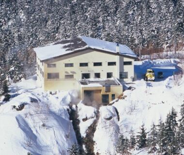 Snow-covered building perched on mountainside at Ryounkaku in Hokkaidō