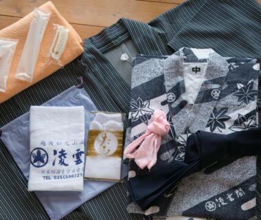 Folded yukata, towels, socks and toiletries laid out for guests at Ryounkaku Matsunoyama in Niigata