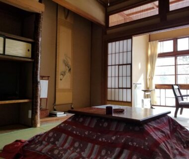 Tatami room with kotatsu, shoji screens and garden view at Ryounkaku Matsunoyama, Niigata