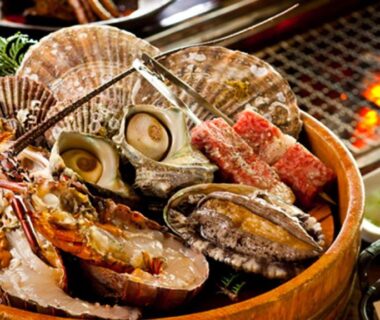 Assorted shellfish and prawns grilling on a grill at Ryouri no yado Ginrin in Mie, Kansai