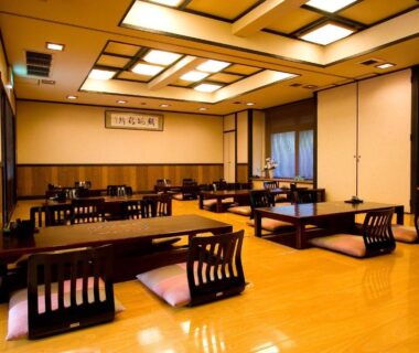 Traditional dining room with low wooden tables and zaisu chairs inside Ryouri no yado Ginrin, Mie